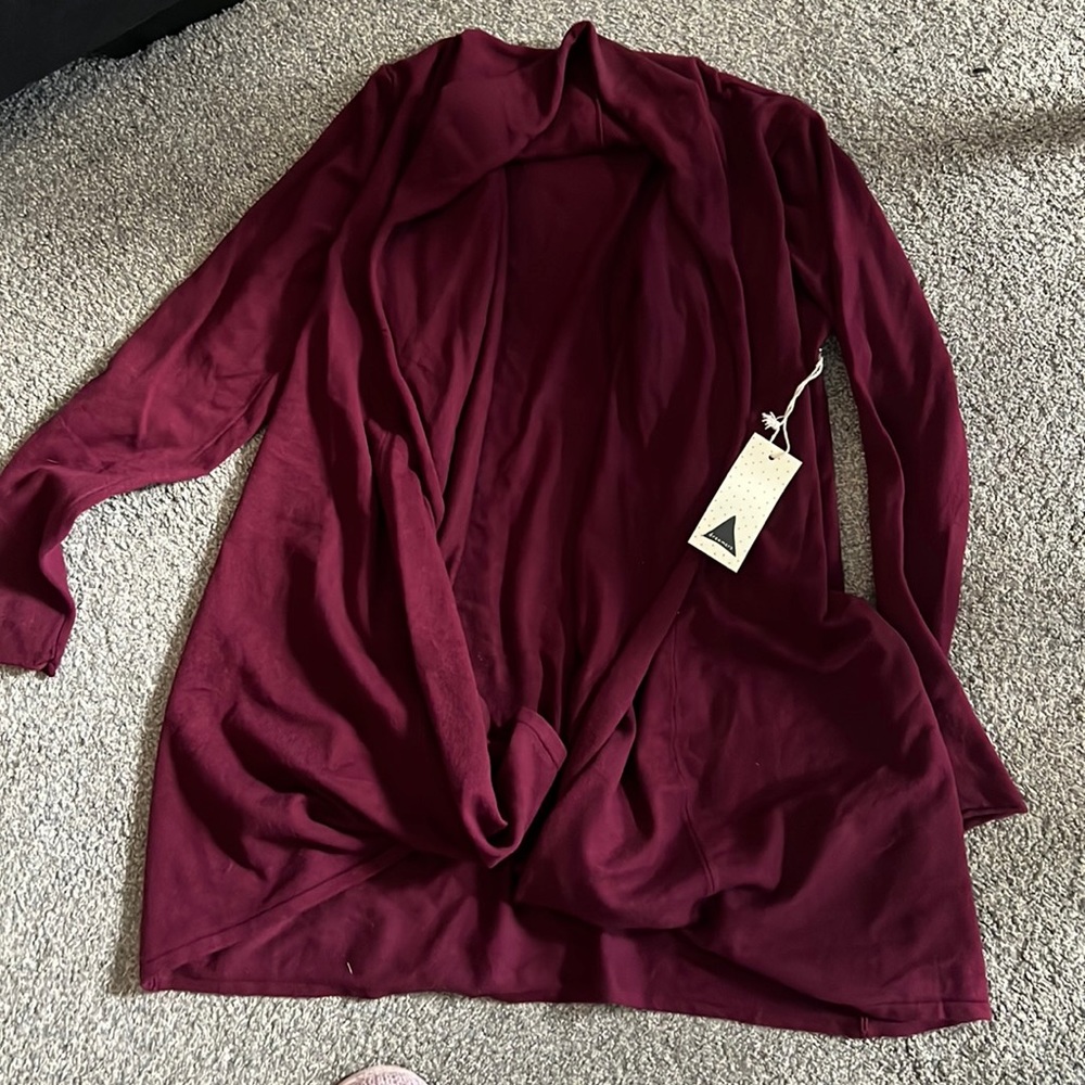 Burgundy red sweater bought from Betsy’s boutique. New with tags on it.